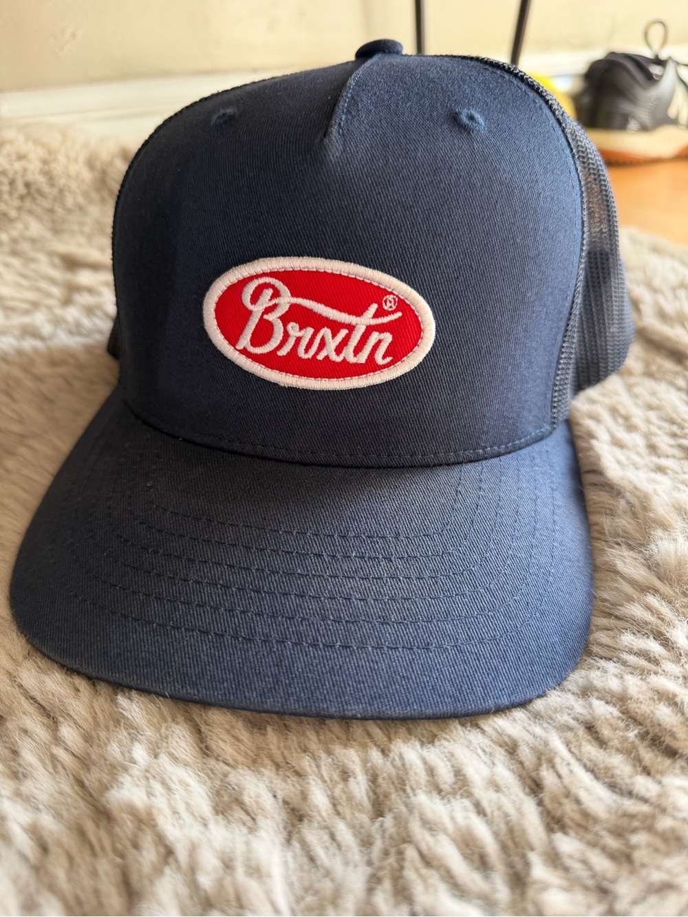 Brixton Navy Trucker Hat with Red Logo Patch
